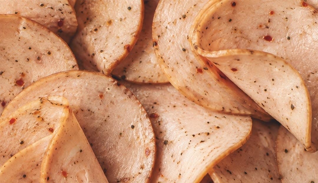 Folded slices of chicken salami
