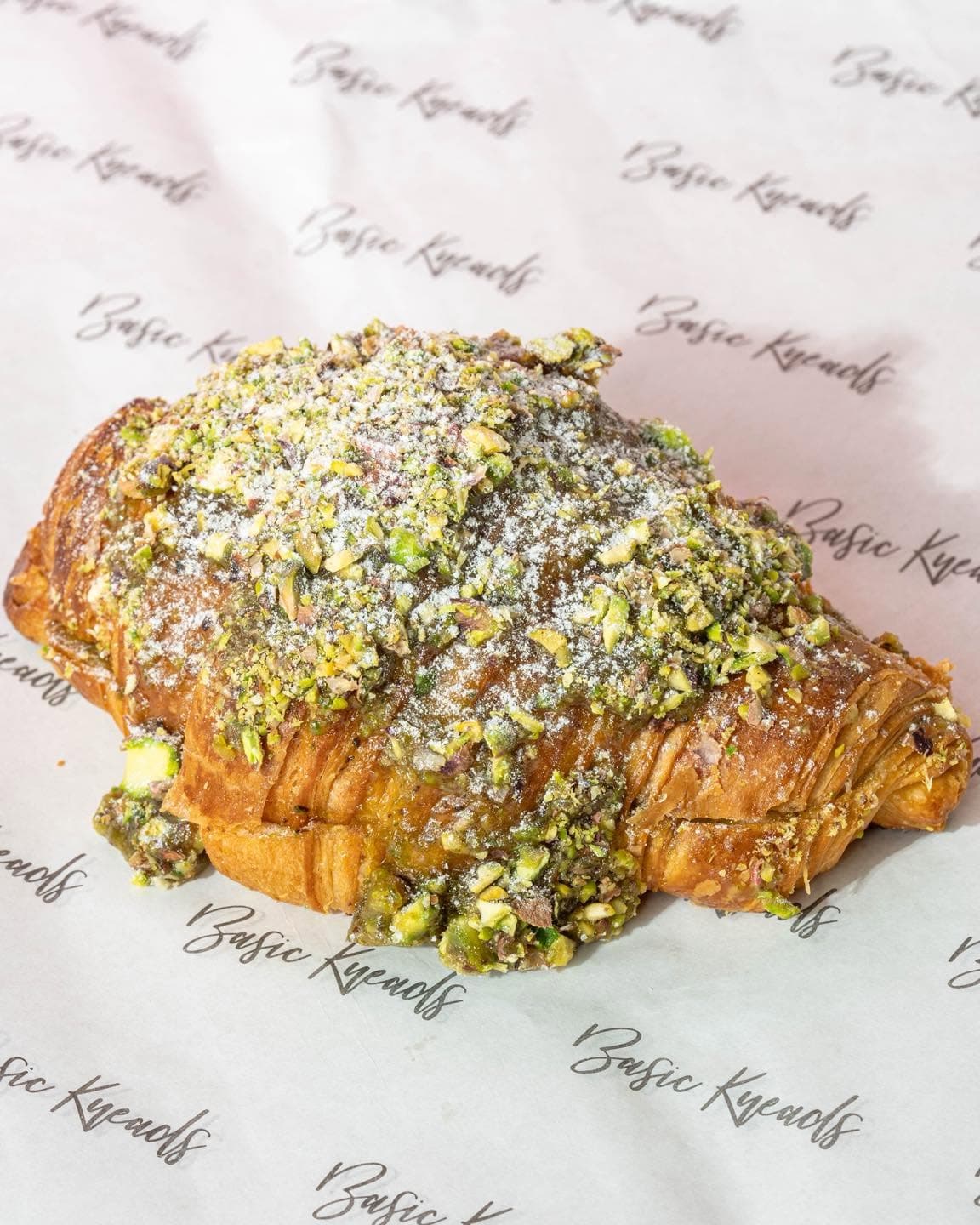 Pistachio Frangipane croissant on Basic Kneads wrapping paper